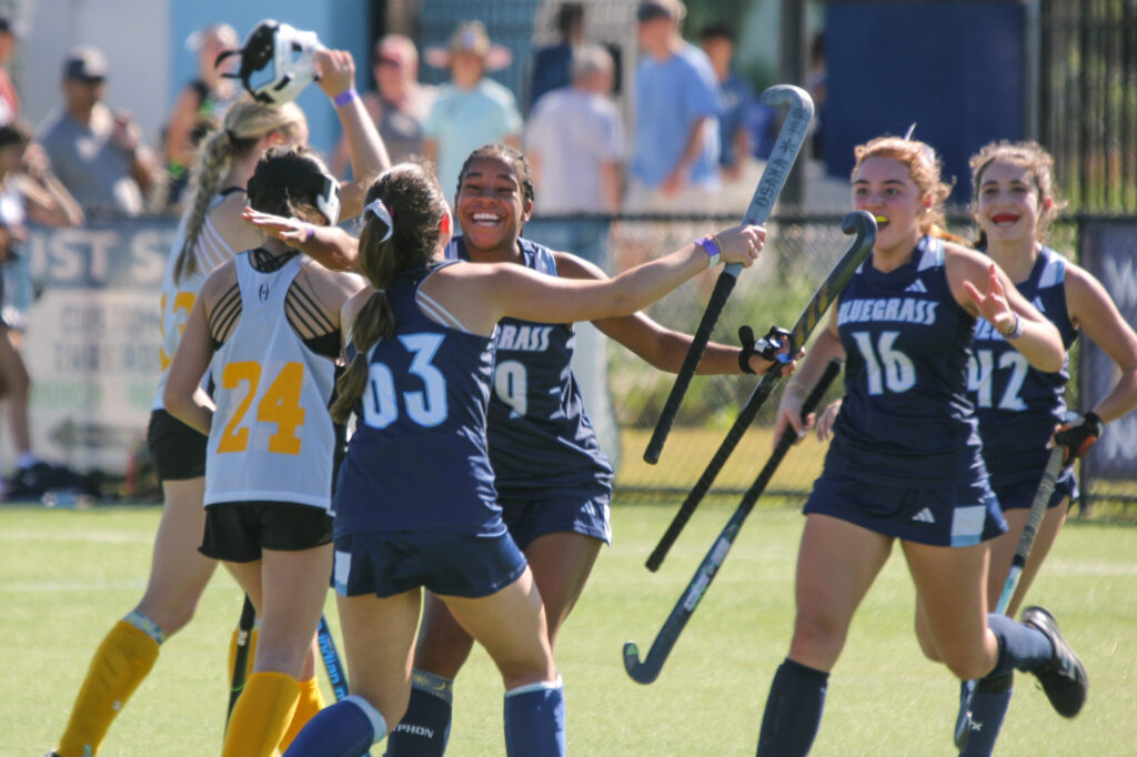 Happy field hockey players celebrating